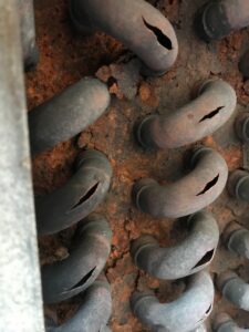 Ruptured HVAC coil with split copper tubes caused by freezing